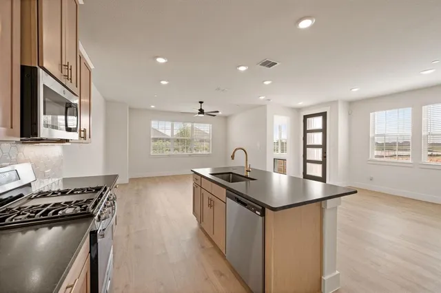 a kitchen that has a sink and a stove in it