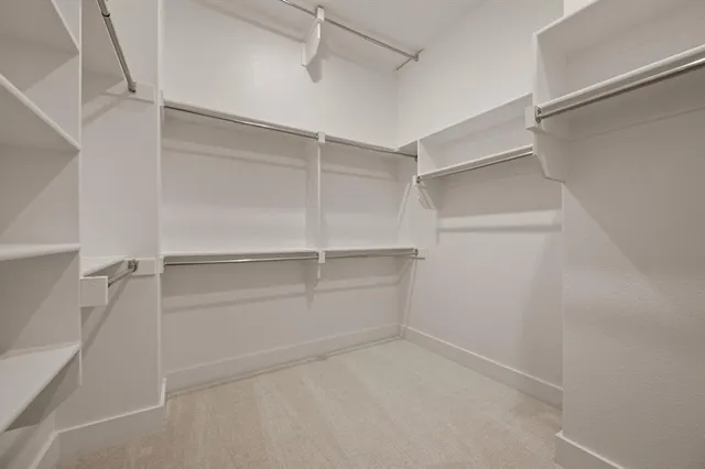 a spacious bathroom with a shower sink and mirror