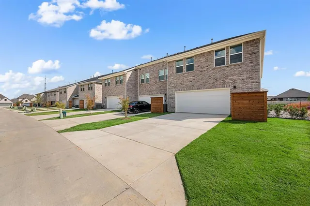 a bathroom with a double vanity sink a toilet a mirror and shower