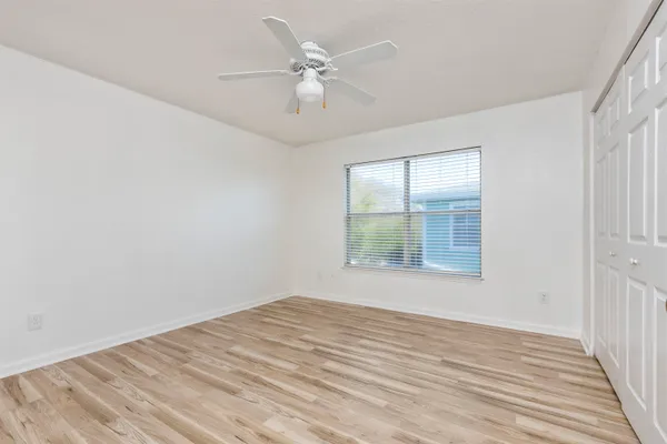 a view of empty room with wooden floor