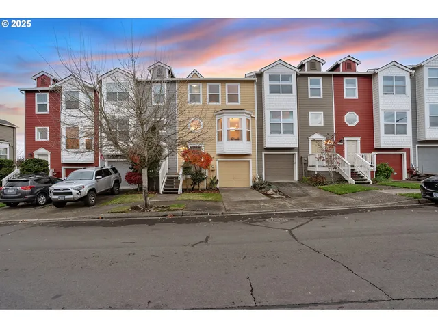 a front view of a residential apartment building with a yard