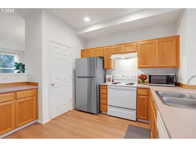 a kitchen with a refrigerator and a stove