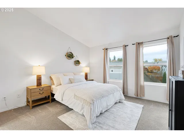 a bedroom with a large bed and a large window