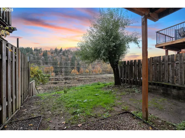 a backyard of a house with table and chairs