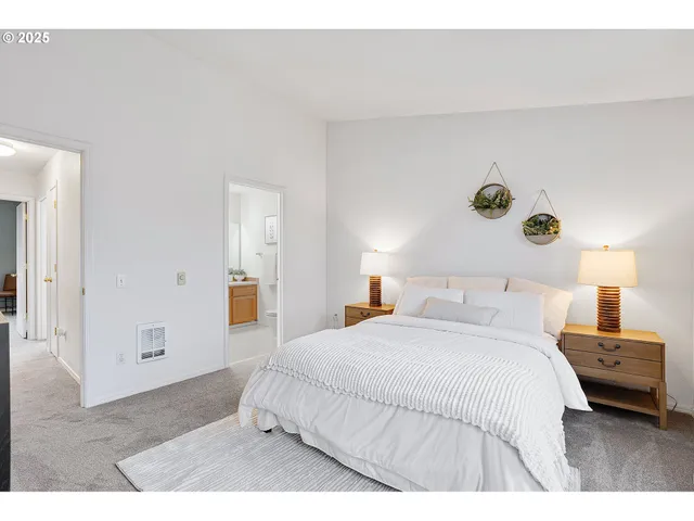 a bedroom with a bed and painting on the wall