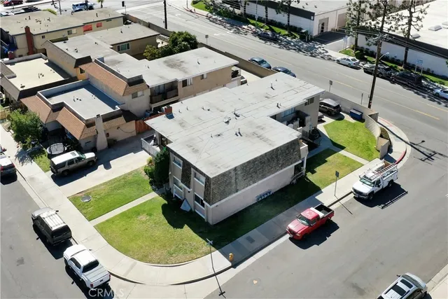 an aerial view of a house with garden space and street view