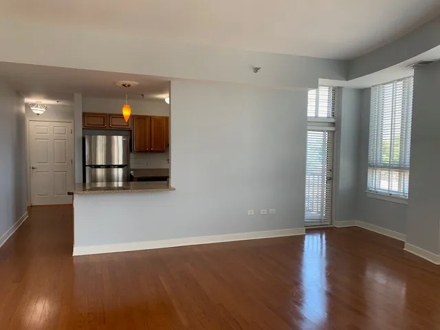 a view of a livingroom with wooden floor and window