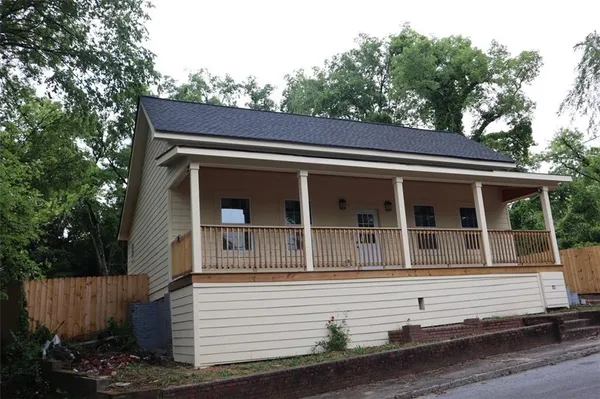 a view of house with tree in front of it
