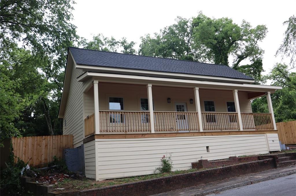 a view of house with tree in front of it