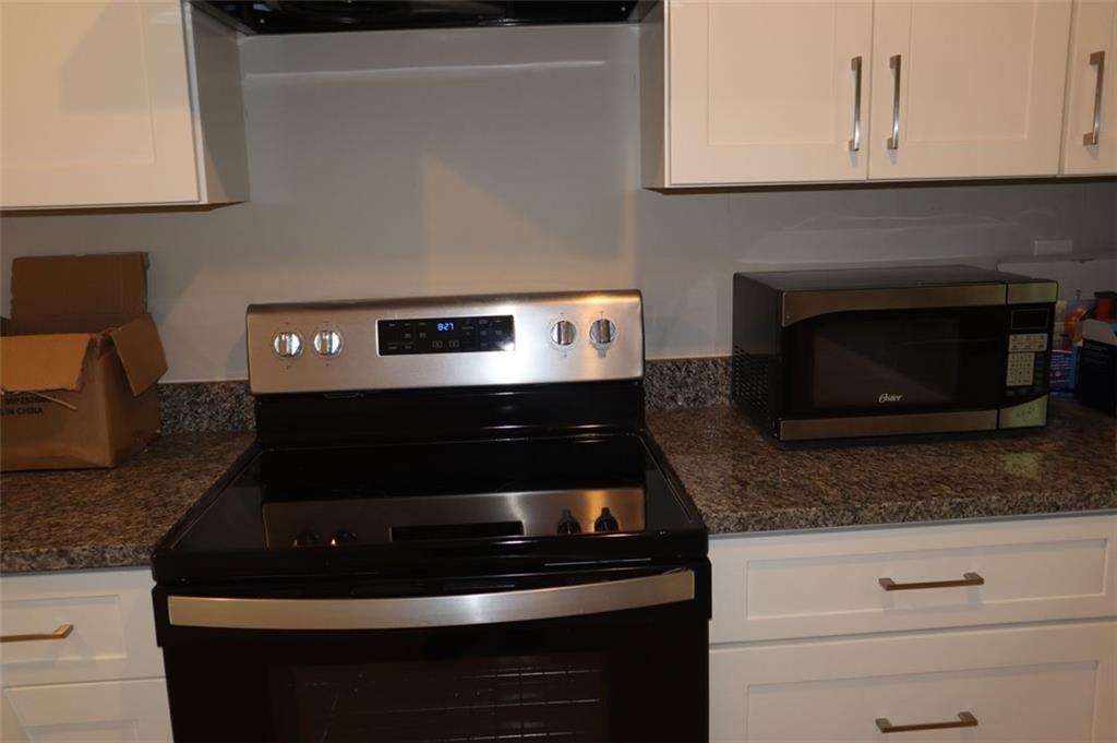 1958 3rd Street Macon, GA 31201 - Photo 12 of 19 a kitchen with a stove and a microwave