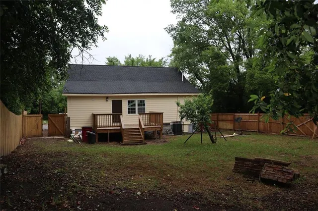 a front view of a house with a garden and trees