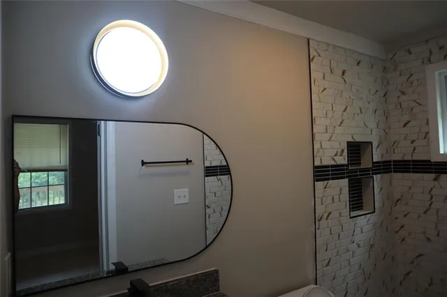 a close view of light fixtures and a mirror of a bathroom