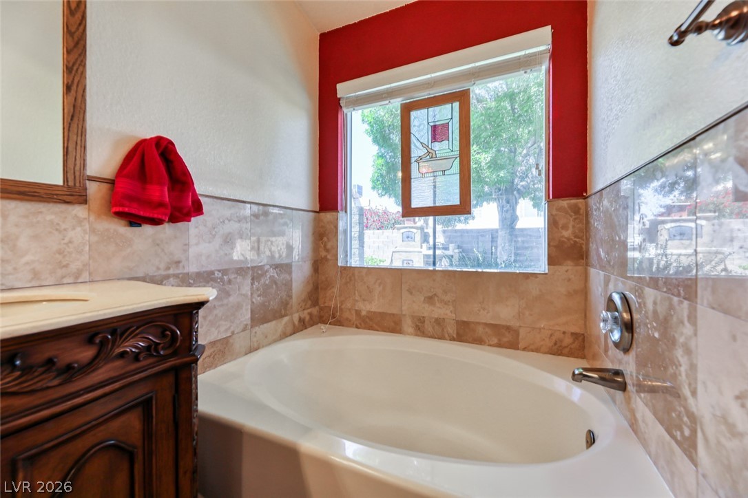 2001 Appaloosa Road Henderson, NV 89002 - Photo 35 of 44 This bathing space offers a clean tub and tiled walls, perfect for unwinding.