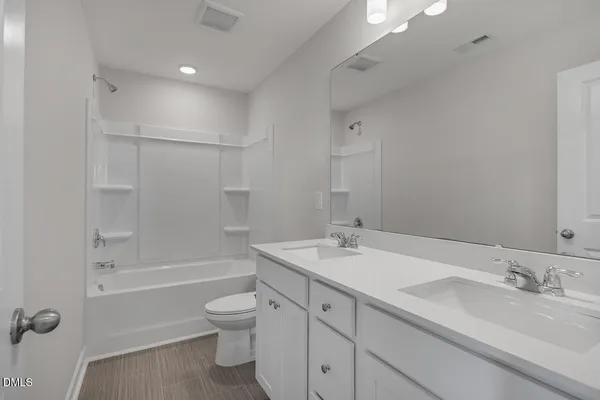 an empty room with windows and bathroom