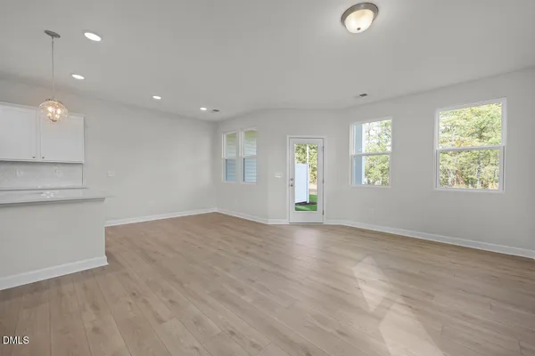 an empty room with windows and entrance