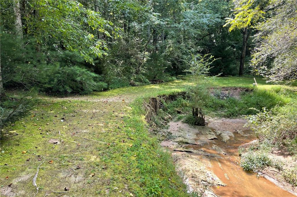 653 Little Elkin Church Road Ronda, NC 28670 - Photo 42 of 47 Creek where Indian artifacts have been found. Woods beyond the creek are easy to hike.
