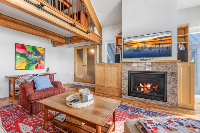 9927 Powder Run Road, Unit 10B Alta, UT 84092 - Photo 7 of 31 Living area featuring wood finished floors and a new fireplace insert