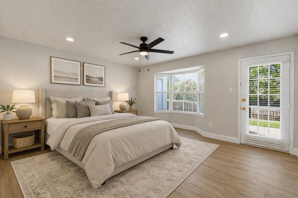 5514 Round Rock Road Garland, TX 75044 - Photo 14 of 37 a spacious bedroom with a large bed and a window