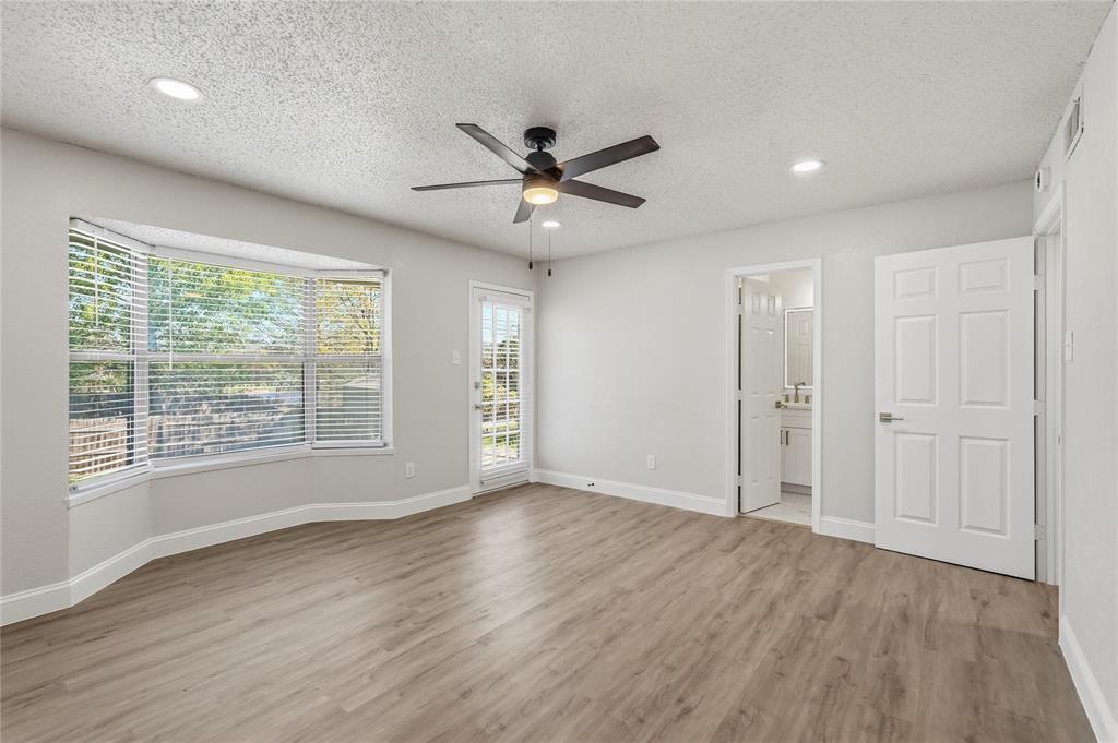 5514 Round Rock Road Garland, TX 75044 - Photo 15 of 37 a view of an empty room with a window and wooden floor