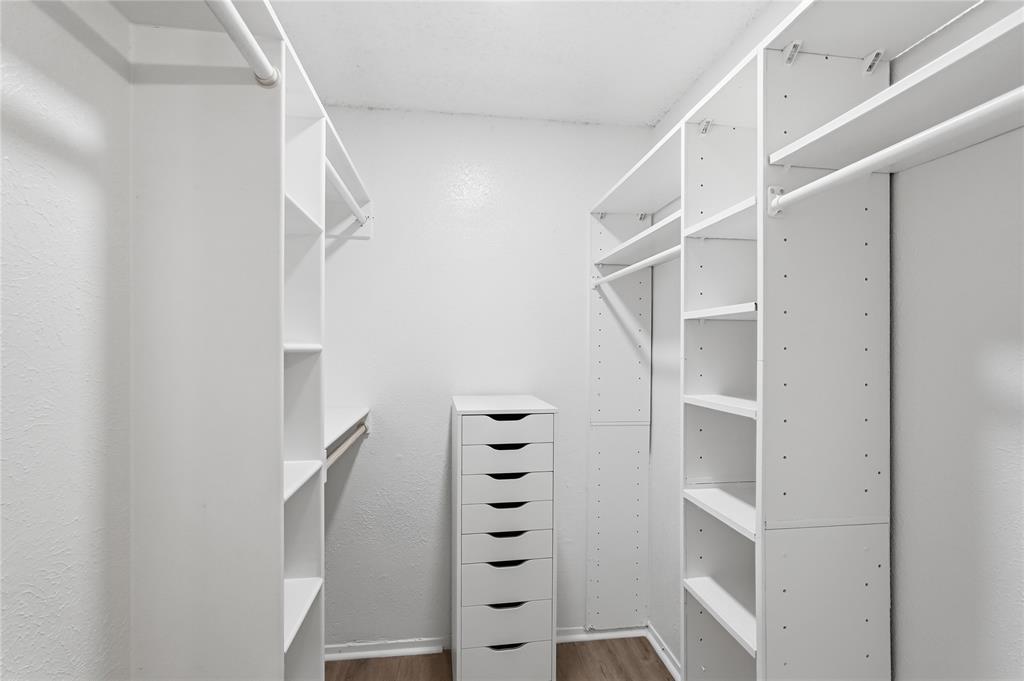 5514 Round Rock Road Garland, TX 75044 - Photo 18 of 37 a view of walk in closet with empty racks