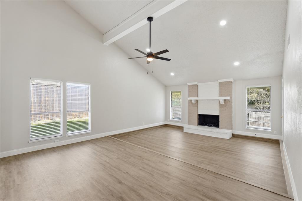5514 Round Rock Road Garland, TX 75044 - Photo 2 of 37 a view of an empty room with wooden floor and a window