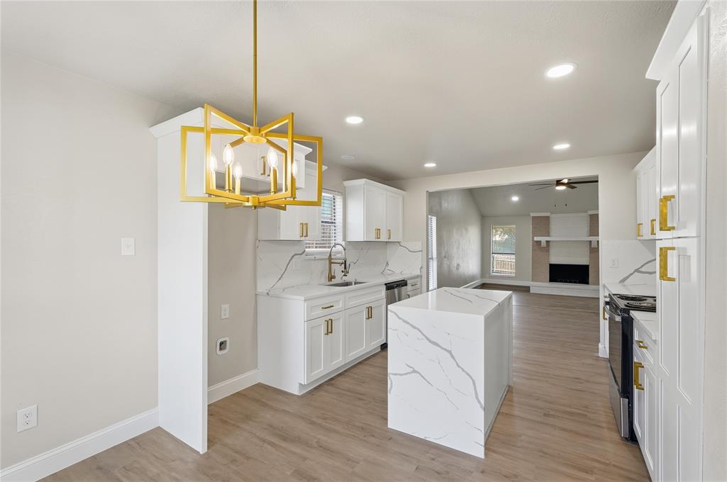 5514 Round Rock Road Garland, TX 75044 - Photo 6 of 37 a large kitchen with stainless steel appliances kitchen island a stove a refrigerator a oven and a sink with large cabinets