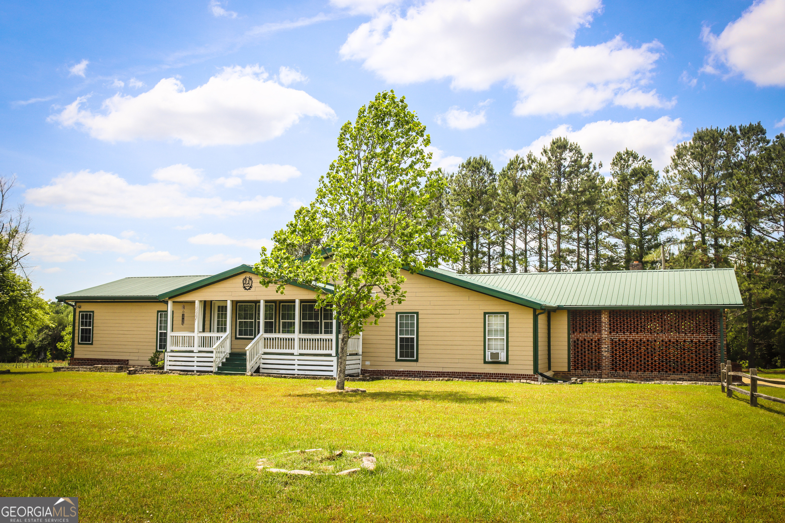 a front view of a house with yard and swimming pool