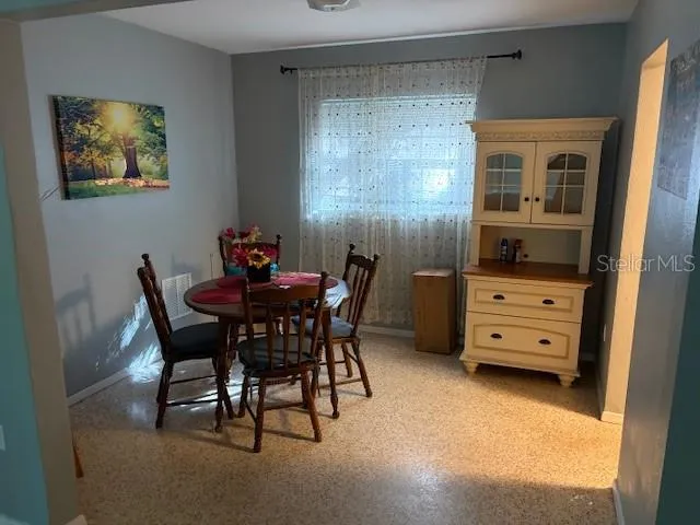 a dining room with furniture and window
