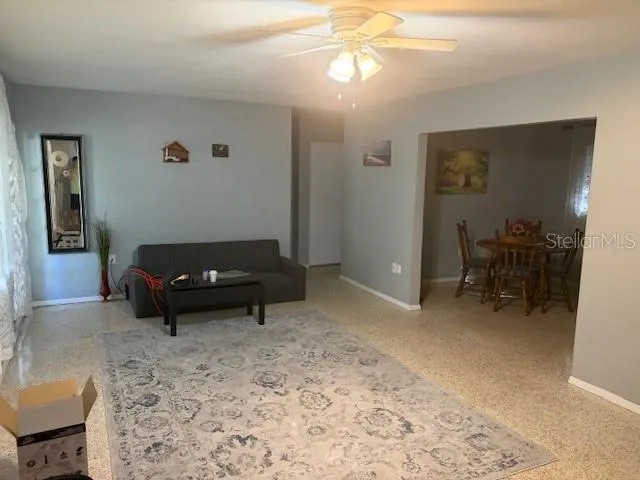 a living room with furniture and a dining table
