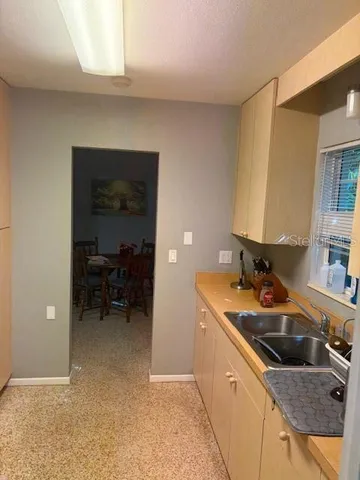 a kitchen that has a sink and a stove in it