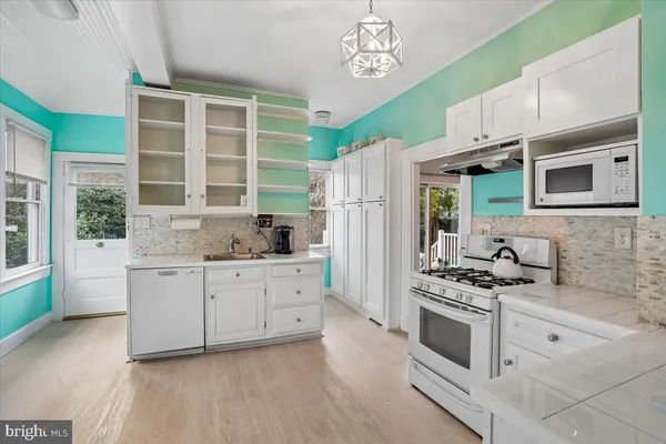 a kitchen with stainless steel appliances a stove a sink and a refrigerator