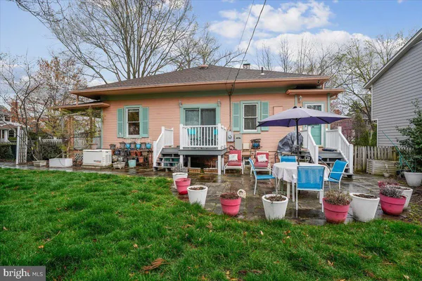 a view of a house with backyard sitting area and garden