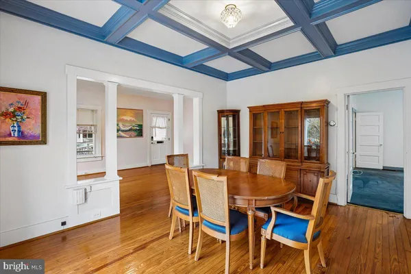 a dining room with furniture and wooden floor