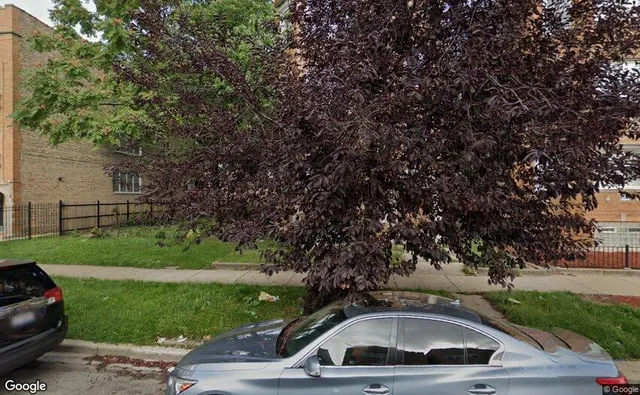 a view of a street with a car parked side of it