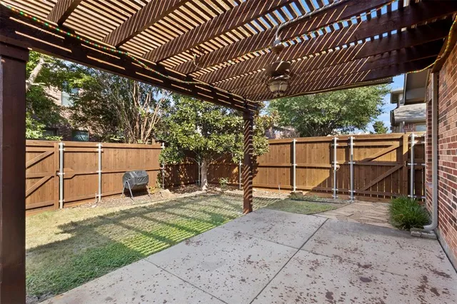 a view of a backyard with wooden fence