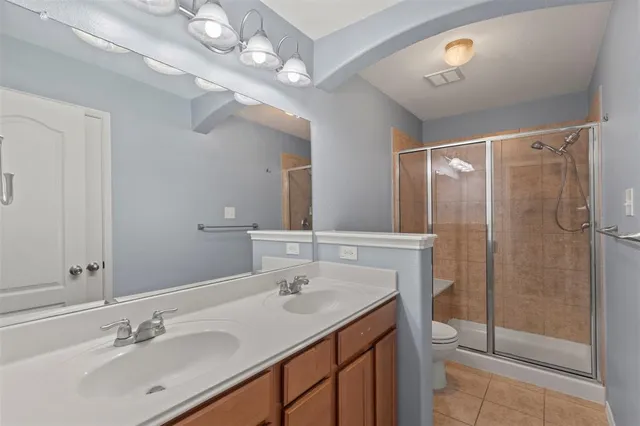 a bathroom with a sink double vanity and shower