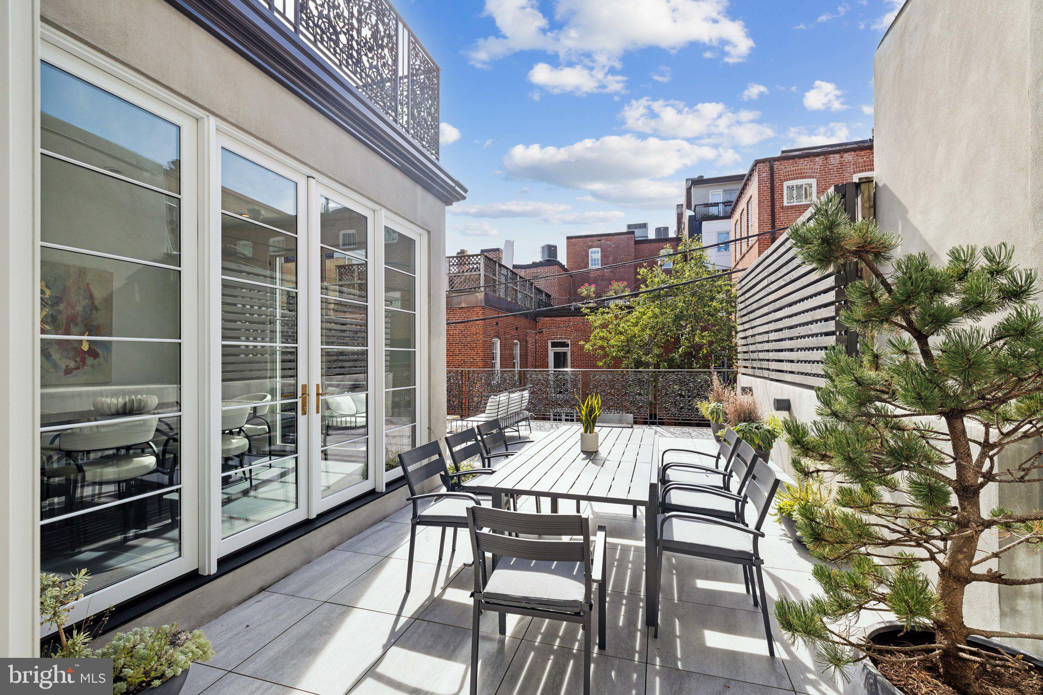 2120 Bancroft Place Northwest Washington, DC 20008 - Photo 14 of 30 a view of a patio with a table and chairs next to a yard