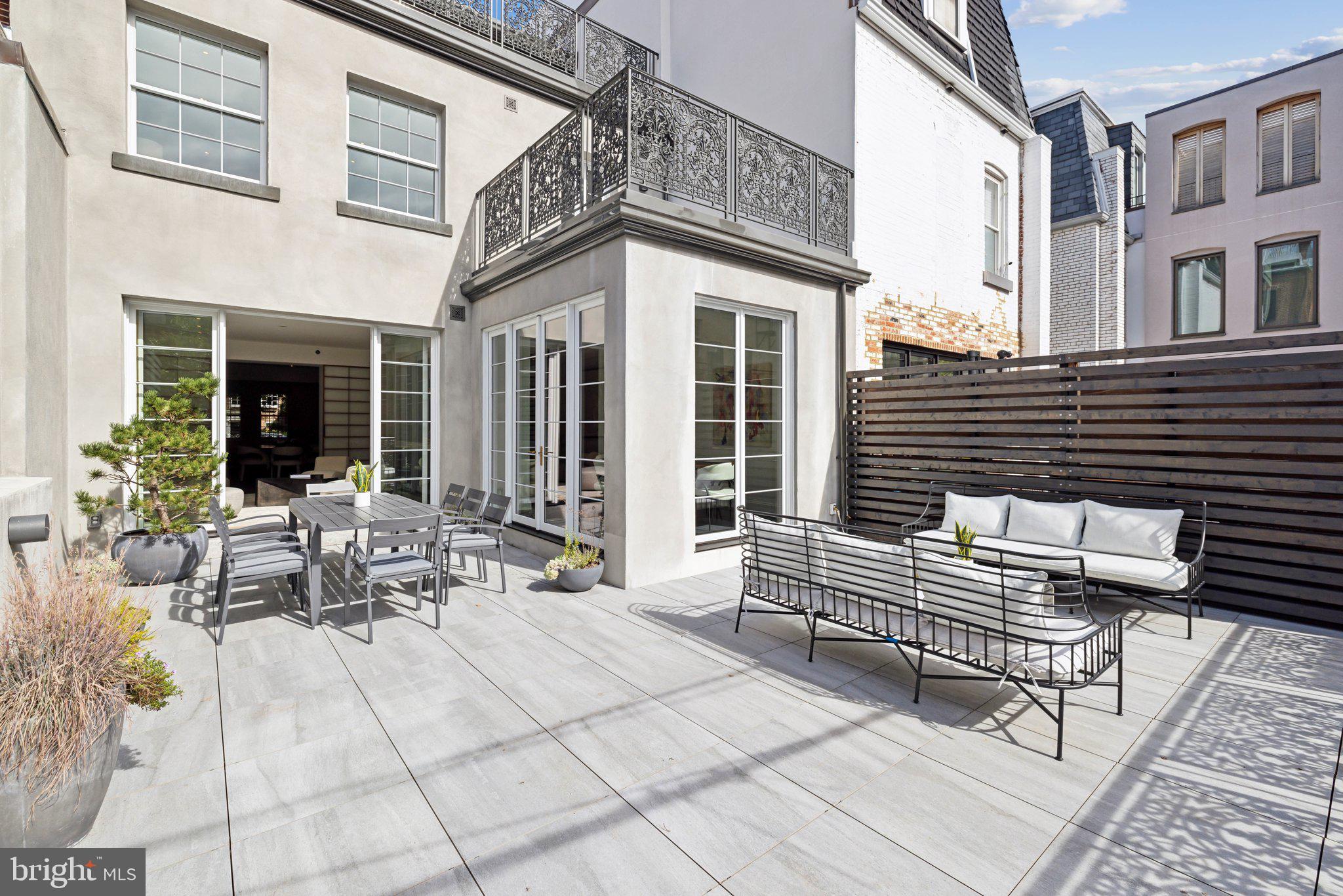 2120 Bancroft Place Northwest Washington, DC 20008 - Photo 15 of 30 a view of a patio with couches table and chairs and potted plants