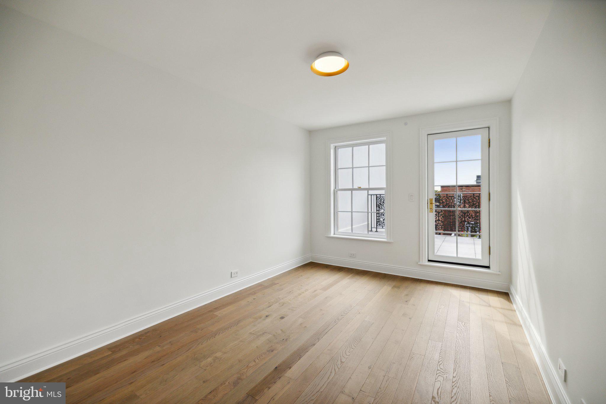 2120 Bancroft Place Northwest Washington, DC 20008 - Photo 25 of 30 an empty room with wooden floor and windows