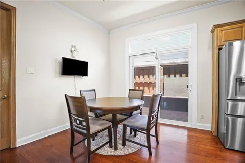 a dining room with furniture and wooden floor