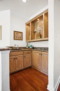 a spacious bathroom with a granite countertop sink and a large mirror
