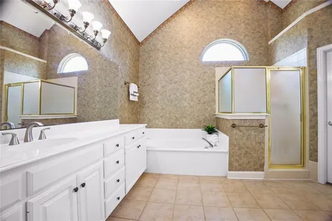 a bathroom with a sink a bathtub and a mirror