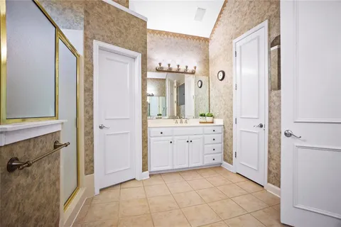 a spacious bathroom with a granite countertop sink a mirror and a