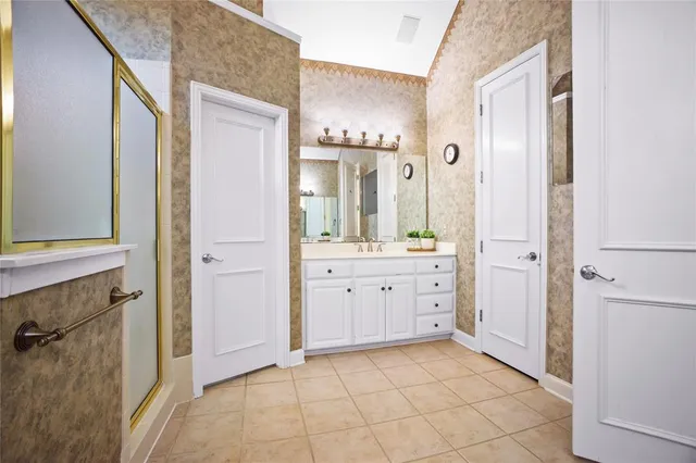 a spacious bathroom with a granite countertop sink a mirror and a