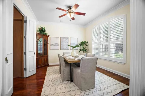 a dining room with furniture window and wooden floor
