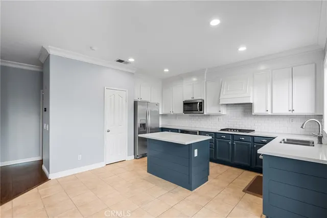 a kitchen with a refrigerator a sink and a oven