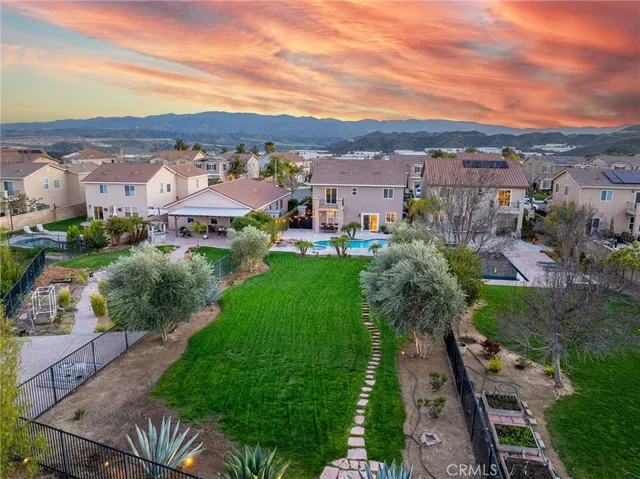 a front view of a house with a garden and plants