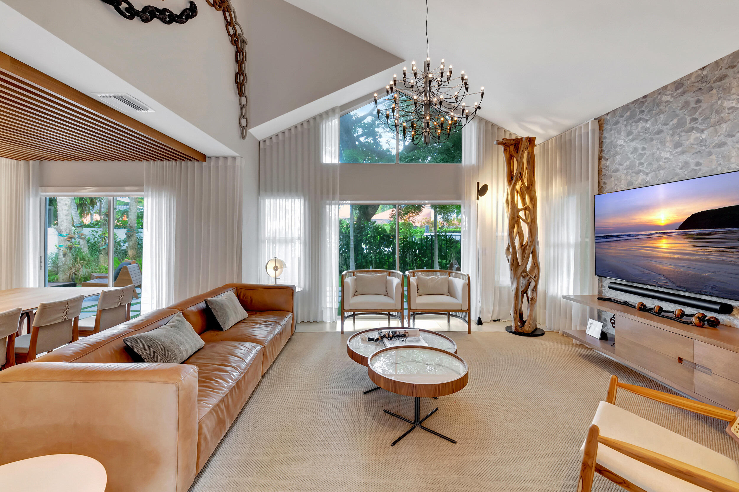 5254 Northwest 22nd Avenue Boca Raton, FL 33496 - Photo 2 of 50 a living room with furniture a flat screen tv and a large window
