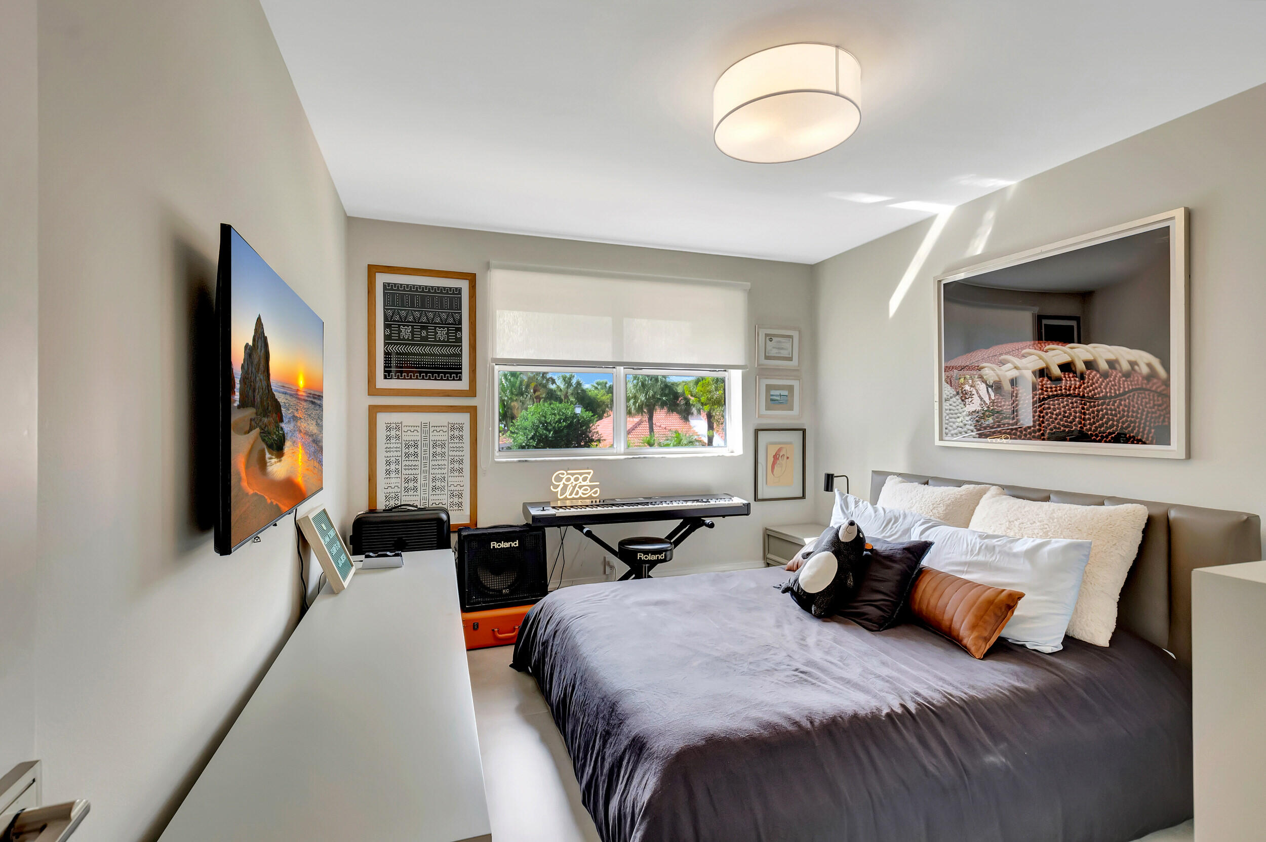 5254 Northwest 22nd Avenue Boca Raton, FL 33496 - Photo 28 of 50 a bedroom with furniture and a flat screen tv