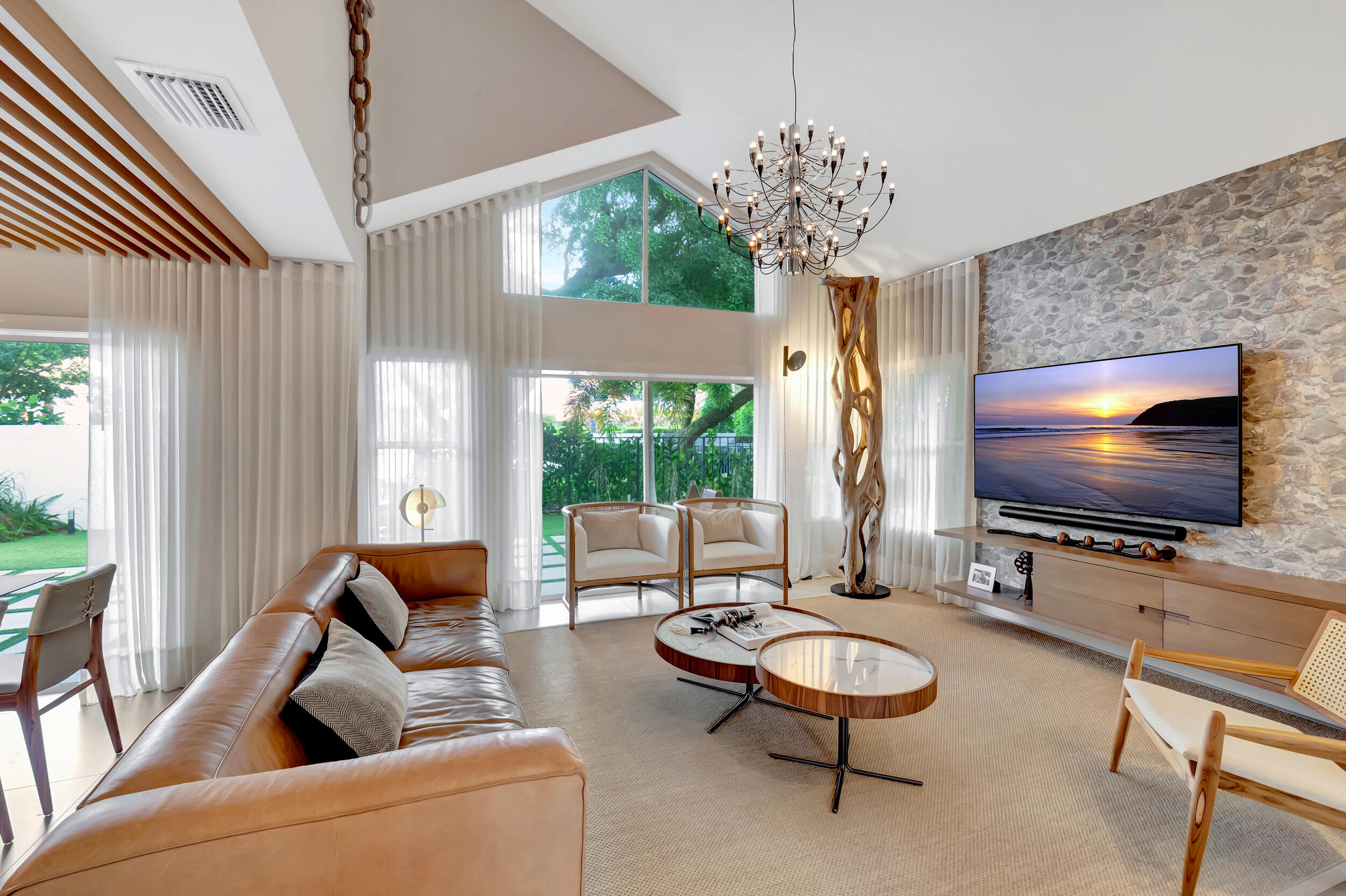 5254 Northwest 22nd Avenue Boca Raton, FL 33496 - Photo 3 of 50 a living room with furniture a flat screen tv and a large window